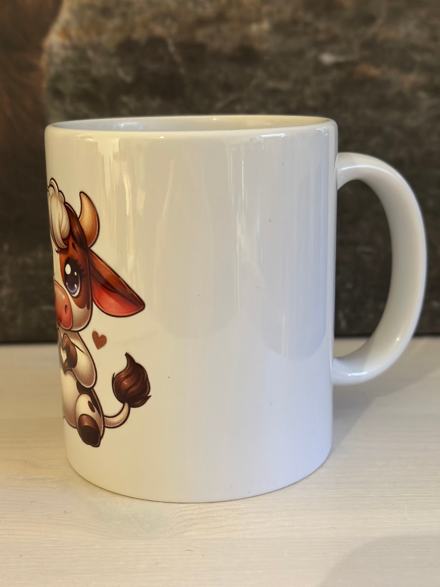 Tasse „Kuh mit Herz sitzend“