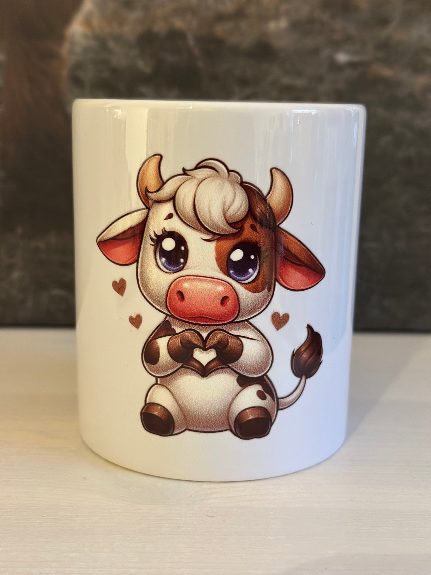 Tasse „Kuh mit Herz sitzend“
